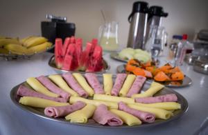 a plate of hot dogs and vegetables on a table at Hotel Melo in Montes Claros