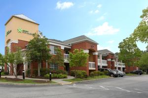 a red brick building with a car parked in front at Extended Stay America Suites - Richmond - West End - I-64 in Short Pump