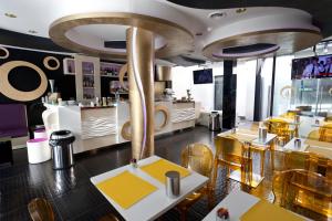 a restaurant with yellow and white tables and chairs at Mille e Una Notte in Nuova Gibellina