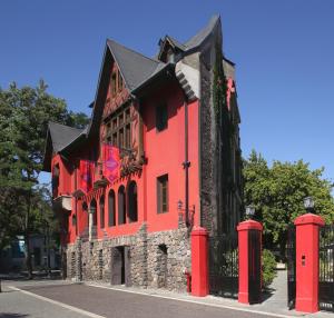 a red brick building with a red fire hydrant at Hotel Boutique Castillo Rojo in Santiago