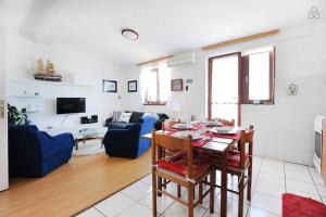 a living room with a table and a blue couch at Apartman Klarin - old stone house in Jezera