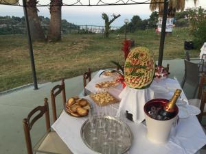 a table with a bottle of wine and a plate of food at Le Limonaie a Mare in San Benedetto del Tronto