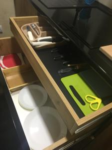 a drawer with scissors and other tools in it at Lola Apartments in Banja Koviljača