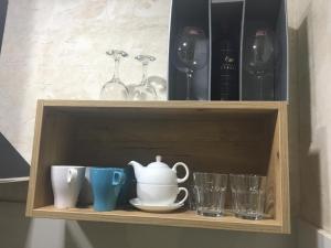 a wooden shelf with cups and glasses on it at Lola Apartments in Banja Koviljača +30 photos