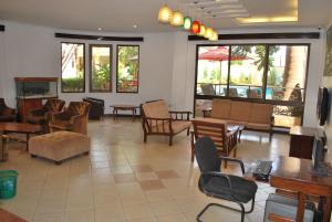 a lobby with chairs and tables and a fireplace at Parkview Inn in Moshi