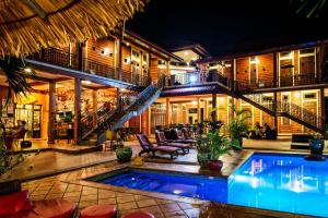 a villa with a swimming pool at night at Villa Vedici in Kampot