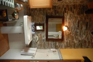 a bathroom with a sink and a mirror at Casa Grande da Ferreria de Rugando in Rugando