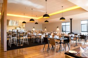 a dining room with tables and chairs at Cradle Mountain Hotel in Cradle Mountain