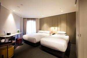 Rúm í herbergi á G2 Hotel Myeongdong