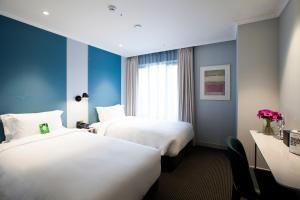 Rúm í herbergi á G2 Hotel Myeongdong