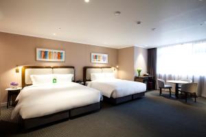 Rúm í herbergi á G2 Hotel Myeongdong