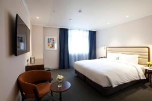 Rúm í herbergi á G2 Hotel Myeongdong
