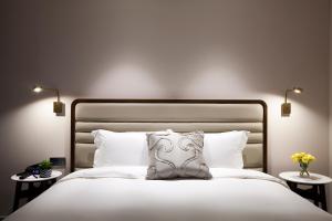 Rúm í herbergi á G2 Hotel Myeongdong