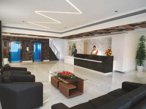 a lobby with couches and a table in a building at The Central Residency in Trivandrum