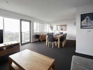 a living room with a table and a dining room at Elkhorn 7 in Mount Buller