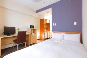 Postel nebo postele na pokoji v ubytování FLEXSTAY INN Ekoda