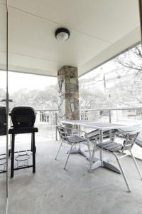 a table and chairs on a porch with a window at Reindeer 9 in Mount Buller