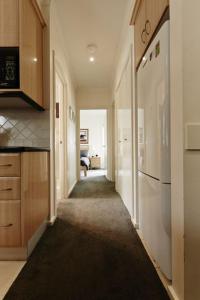 a hallway of a kitchen with a refrigerator at Reindeer 9 in Mount Buller