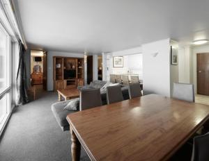a living room with a table and a dining room at Twin Towers 502A in Mount Buller