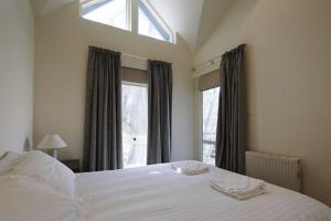 a bedroom with a large bed and a window at Whistler 2 in Mount Buller