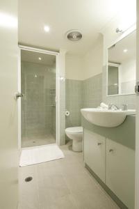 a white bathroom with a sink and a toilet at Whistler 2 in Mount Buller