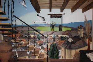 a mural on the wall of a room with birds at Casa el Aljibe in Lanaja