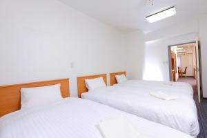 Postel nebo postele na pokoji v ubytování FLEXSTAY INN Tokiwadai