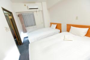 Postel nebo postele na pokoji v ubytování FLEXSTAY INN Tokiwadai
