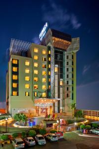 a hotel with cars parked in front of it at The Regenza By Tunga in Navi Mumbai