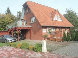 a house with a car parked in front of it at Tor zum Darss in Pruchten