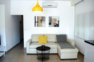 a living room with a couch and a table at El Jardin BeNerja in Nerja