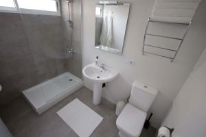 a white bathroom with a toilet and a sink at Apartment Terrace Benalmádena in San Francisco