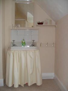 a bathroom with a sink with a curtain around it at The Florida Guest House in Paignton