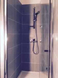 a bathroom with a shower with a glass door at Casale a Figa Bianca in Patrimonio