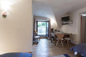 a bedroom with a bed and a dining room with a table at Bed end breakfast du centre in Bourg-Saint-Maurice
