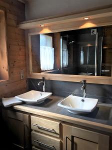 two sinks on a counter in a bathroom at Chalet Clos Moccand in Samoëns