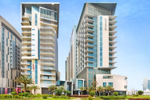 a group of tall buildings in a city at Novotel Abu Dhabi Al Bustan in Abu Dhabi