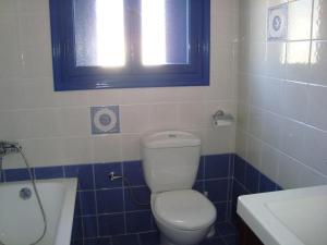 a bathroom with a toilet and a sink and a window at Wide sea Maisonette in Agios Dimitrios +11 photos
