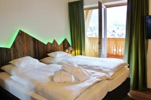 Łóżko lub łóżka w pokoju w obiekcie Hotel Seelos