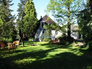 クサンテンにあるFerienwohnung HeeserBerg Xantenの椅子のある庭と階段のある家