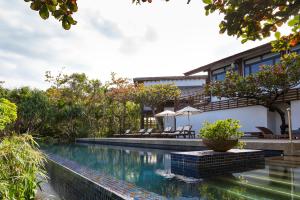 a swimming pool in front of a house at Mudanwan Villa in Mudan