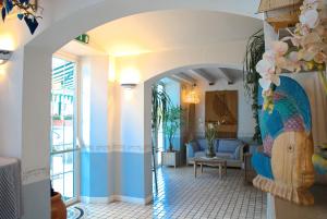 a hallway with a living room with a blue and white at Hotel La Goletta in Lignano Sabbiadoro