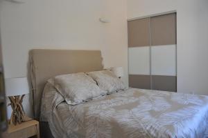 a bedroom with a bed with white sheets and a window at Villa Valflor chambres d'hôtes et appartements in Marseille