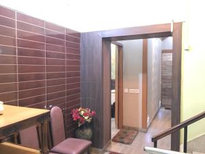a room with a table and a vase of flowers at Nalanda Hotel in Jamshedpur