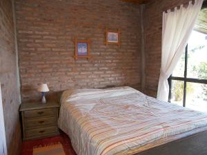 Кровать или кровати в номере Posada del Barranco Apart & Suites