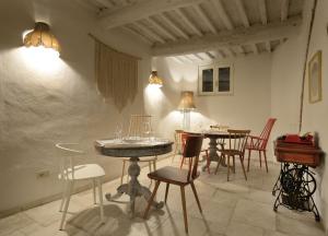 a dining room with tables and chairs and lights at Le camere di Sementis in Pietrasanta
