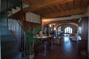 a living room with a staircase and a table and chairs at Arpaderba B&B in Livorno