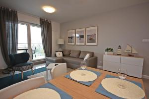 a living room with a table and two wine glasses at Giżycko - Wilkasy - Apartamenty - ApartMazury in Wilkasy