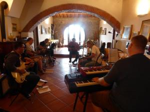 a group of people sitting in a room playing keyboards at Arpaderba B&B in Livorno