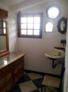 a bathroom with a sink and a mirror at Hotel Paraiso Escondido in Puerto Escondido